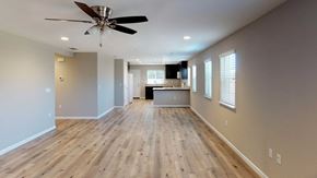 Pittsburg apartment for rent - A spacious room with wooden flooring and a ceiling fan.