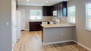 Pittsburg apartment for rent - A kitchen with a white fridge, a white stove, and a white countertop.