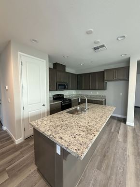 Chico apartment for rent - A kitchen with a granite countertop and wooden flooring.