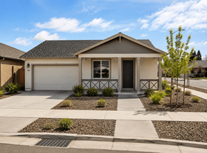 Chico apartment for rent - A house with a white garage door and a small front yard with a tree.