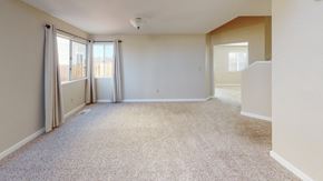 Suisun City house for rent - A spacious room with carpeted floor and sliding glass doors.