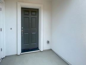 Bay Point apartment for rent - A dark grey door is in a white room.