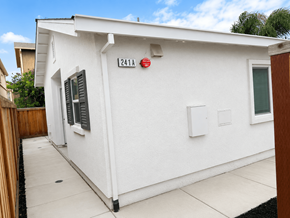 Bay Point apartment for rent - A white house with a red fire alarm on the wall.