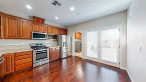 Fairfield apartment for rent - A kitchen with wooden cabinets and a stainless steel refrigerator.