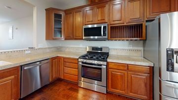 Fairfield apartment for rent - A kitchen with wooden cabinets and stainless steel appliances.