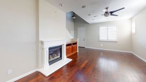 Fairfield apartment for rent - A room with a fireplace and wood flooring.