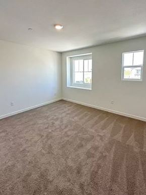 Chico apartment for rent - A room with carpeted floor and two windows.