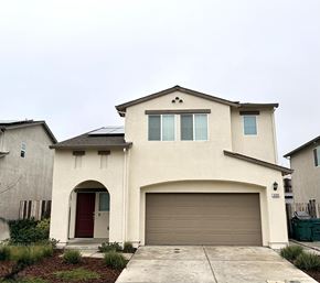 Chico apartment for rent - A two-story house with a red door and a garage door.