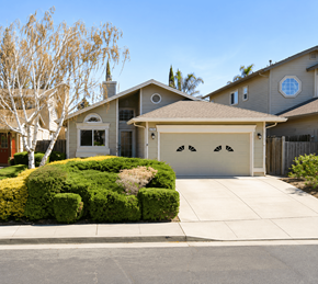 Pittsburg apartment for rent - A house with a garage and a tree in front.