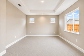 Chico apartment for rent - A large empty room with carpeted floor and two windows.