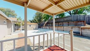 Vacaville apartment for rent - A patio with a white railing and a red mat on the floor.