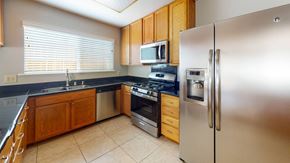 Vacaville apartment for rent - A kitchen with a stainless steel refrigerator, oven, and microwave.
