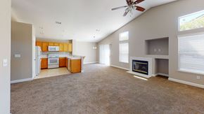 Bay Point apartment for rent - A spacious living room with a fireplace and a ceiling fan.