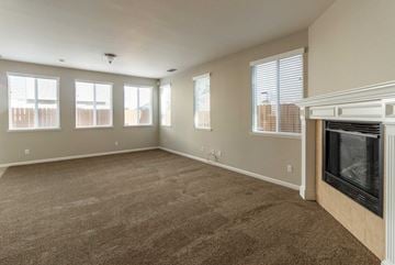 Pittsburg apartment for rent - A living room with a fireplace and carpeted floor.
