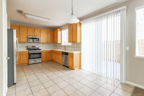 Pittsburg apartment for rent - A kitchen with wooden cabinets and white appliances.