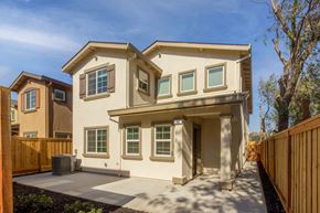 Pittsburg apartment for rent - A two-story house with a brown fence in front.