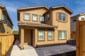Pittsburg apartment for rent - A tan house with a brown fence in front.