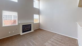 Vacaville apartment for rent - A living room with a fireplace and carpeted floor.
