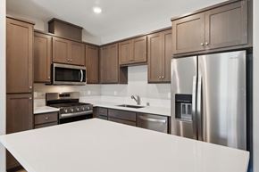 Vacaville house for rent - A Kitchen with Brown Cabinets at Montessa Apartments, California