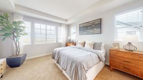 Fairfield apartment for rent - A bedroom with a bed, dresser, and a plant.