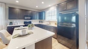 Fairfield apartment for rent - A modern kitchen with a white island and dark brown cabinets.