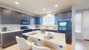 Fairfield apartment for rent - A modern kitchen with dark brown cabinets and a white island.