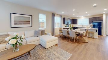Fairfield apartment for rent - A modern living room with a white sofa, a coffee table, and a dining table set up.