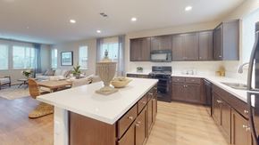 Fairfield apartment for rent - A modern kitchen with dark brown cabinets and a white countertop.