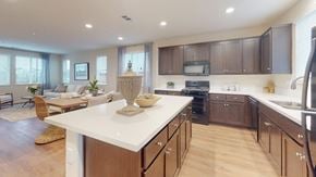 Fairfield apartment for rent - A modern kitchen with dark brown cabinets and a white countertop.