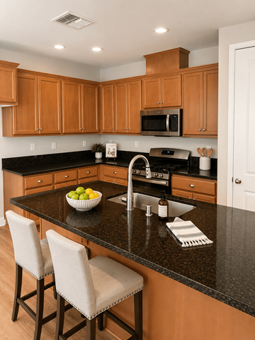 Chico house for rent - A kitchen with wooden cabinets and black countertops.