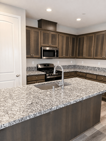 Chico house for rent - A kitchen with a granite countertop and stainless steel sink.