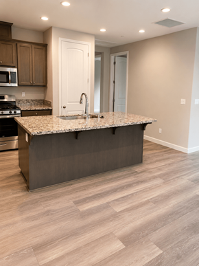 Chico apartment for rent - A kitchen with a granite countertop and wooden cabinets.
