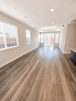 Chico house for rent - A spacious room with wooden flooring and a large window.