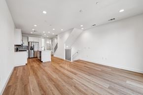 Martinez townhouse for rent - A spacious room with wooden flooring and white walls.