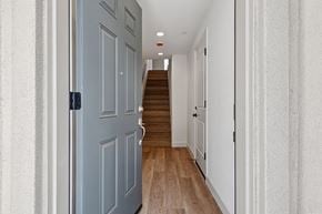 Martinez townhouse for rent - A hallway with a staircase and a closed door.