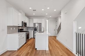 Martinez townhouse for rent - A white kitchen with wood floors and a staircase.
