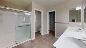 Suisun City apartment for rent - A bathroom with a sink, mirror, and shower.