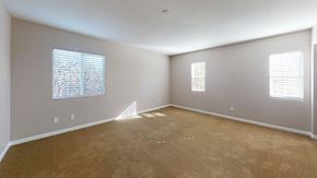 Suisun City apartment for rent - A room with carpeted floor and two windows.