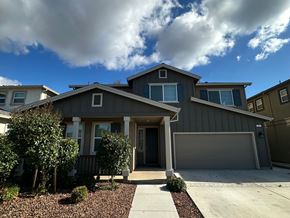 Chico apartment for rent - A house with a grey roof and a brown garage door.
