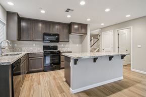 Bay Point apartment for rent - A kitchen with a granite countertop and wooden cabinets.