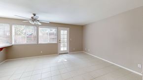 Vacaville apartment for rent - A room with a ceiling fan and sliding glass doors.