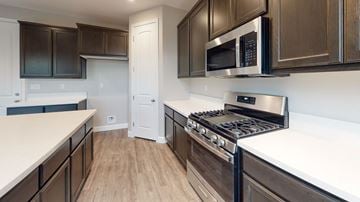 Chico apartment for rent - A kitchen with a white counter top and a black stove.