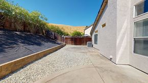 Bay Point apartment for rent - A house with a gravel driveway and a covered patio area.