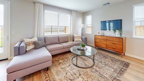 Fairfield apartment for rent - A living room with a grey couch, a glass table, and a wooden cabinet.