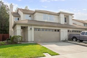 Vacaville apartment for rent - A house with a garage and a truck parked in front.