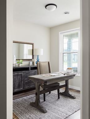 Rochester apartment for rent - A dining room with a wooden table and chairs.