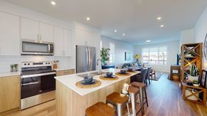 Okotoks apartment for rent - A modern kitchen with a wooden island and stainless steel appliances.