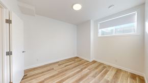 Okotoks apartment for rent - A room with wooden flooring and a window with blinds.