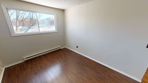 Fredericton apartment for rent - A room with a window and a wooden floor.