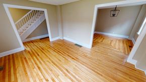 Fredericton apartment for rent - A room with wooden floors and a staircase.